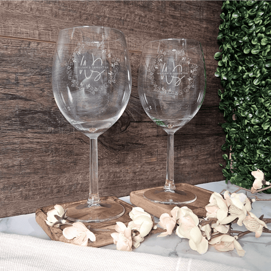 two wine glasses sitting next to each other on a table