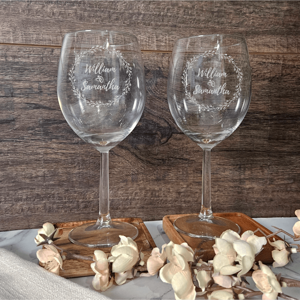 two wine glasses sitting on top of a table