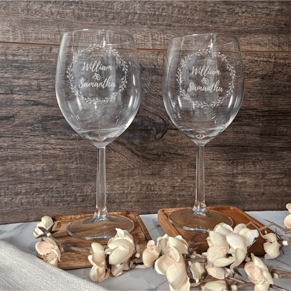 two wine glasses sitting on top of a table