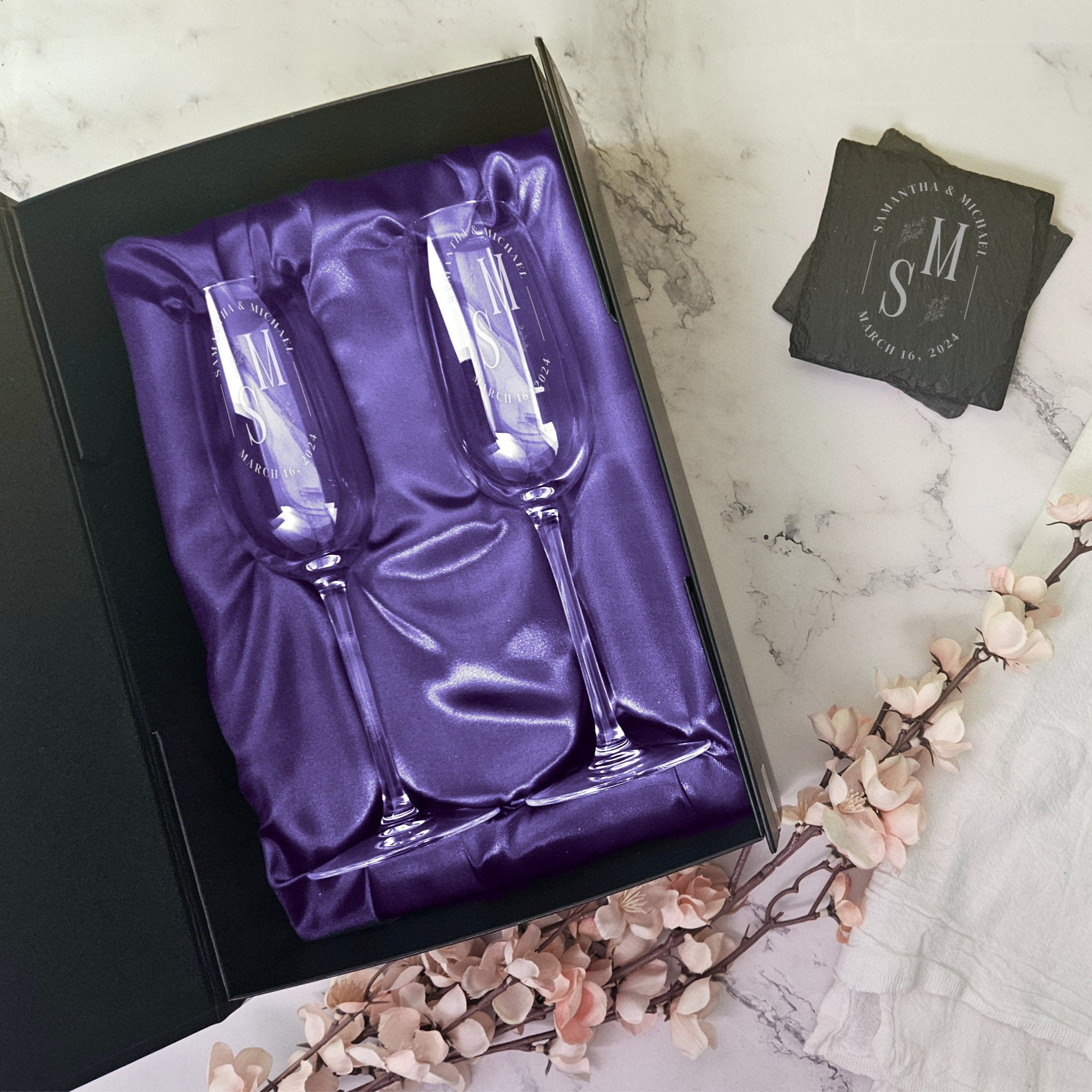 a box of silverware next to a glass of wine