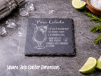 Slate coaster with Pina Colada recipe and measurements on a dark surface with cocktail ingredients.