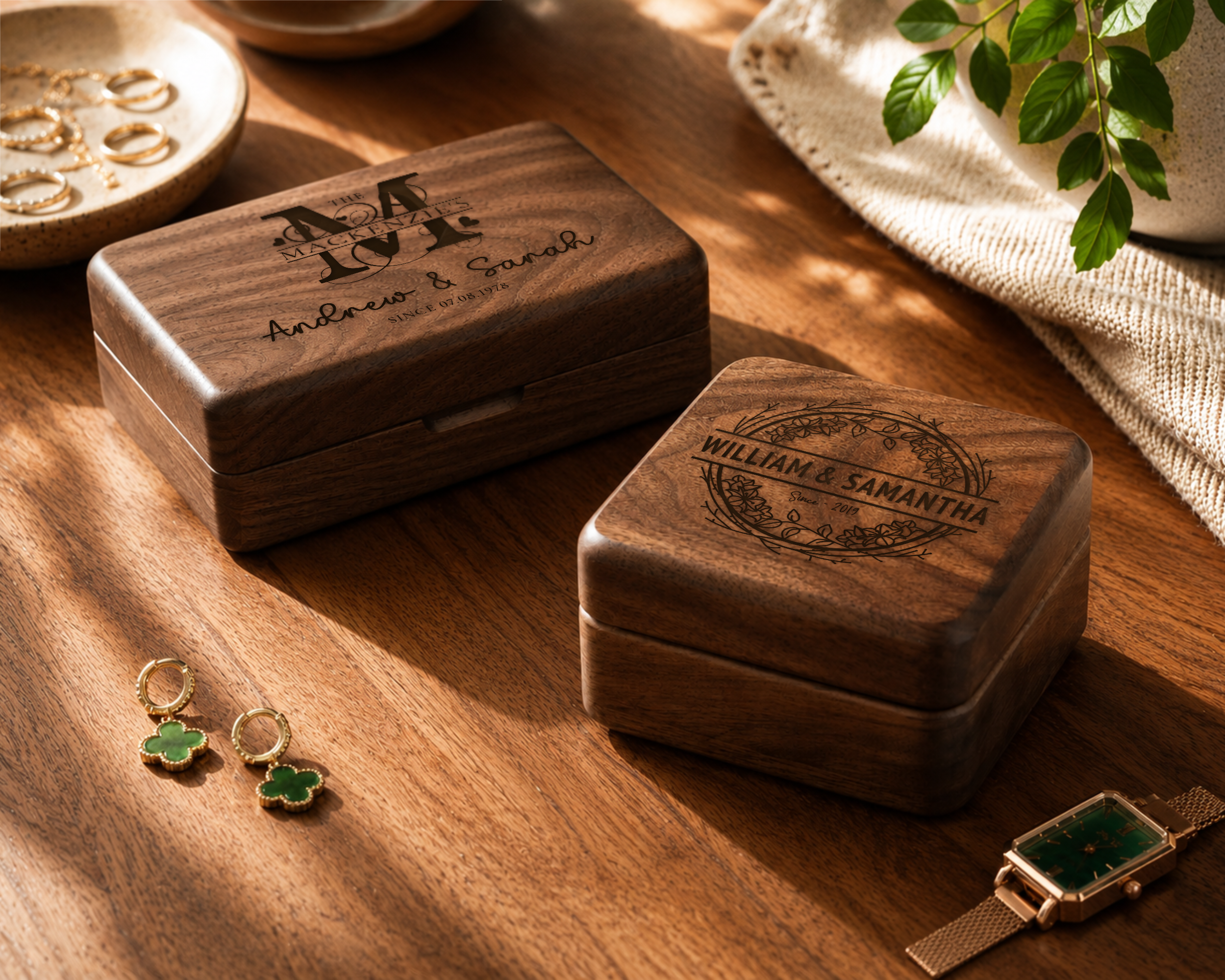Wooden jewelry boxes with engraved names on a wooden surface