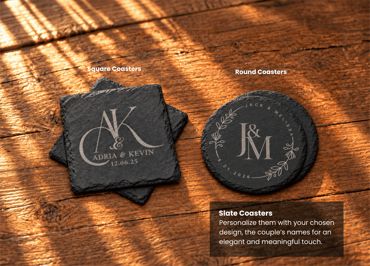 Two engraved slate coasters are displayed on a wooden tabletop: a square coaster on the left and a round coaster on the right. The coasters are dark charcoal gray with light engraved lettering and decorative flourishes.
