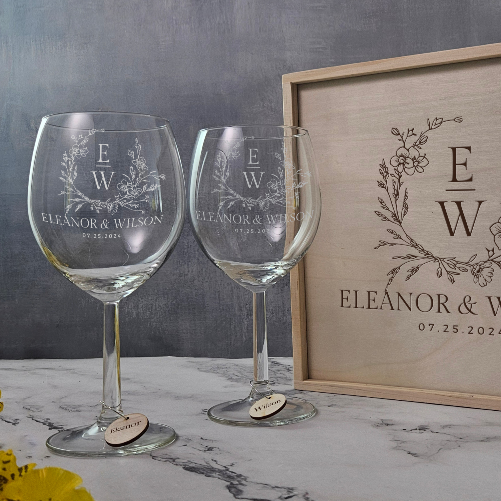 a couple of wine glasses sitting next to a bottle of wine