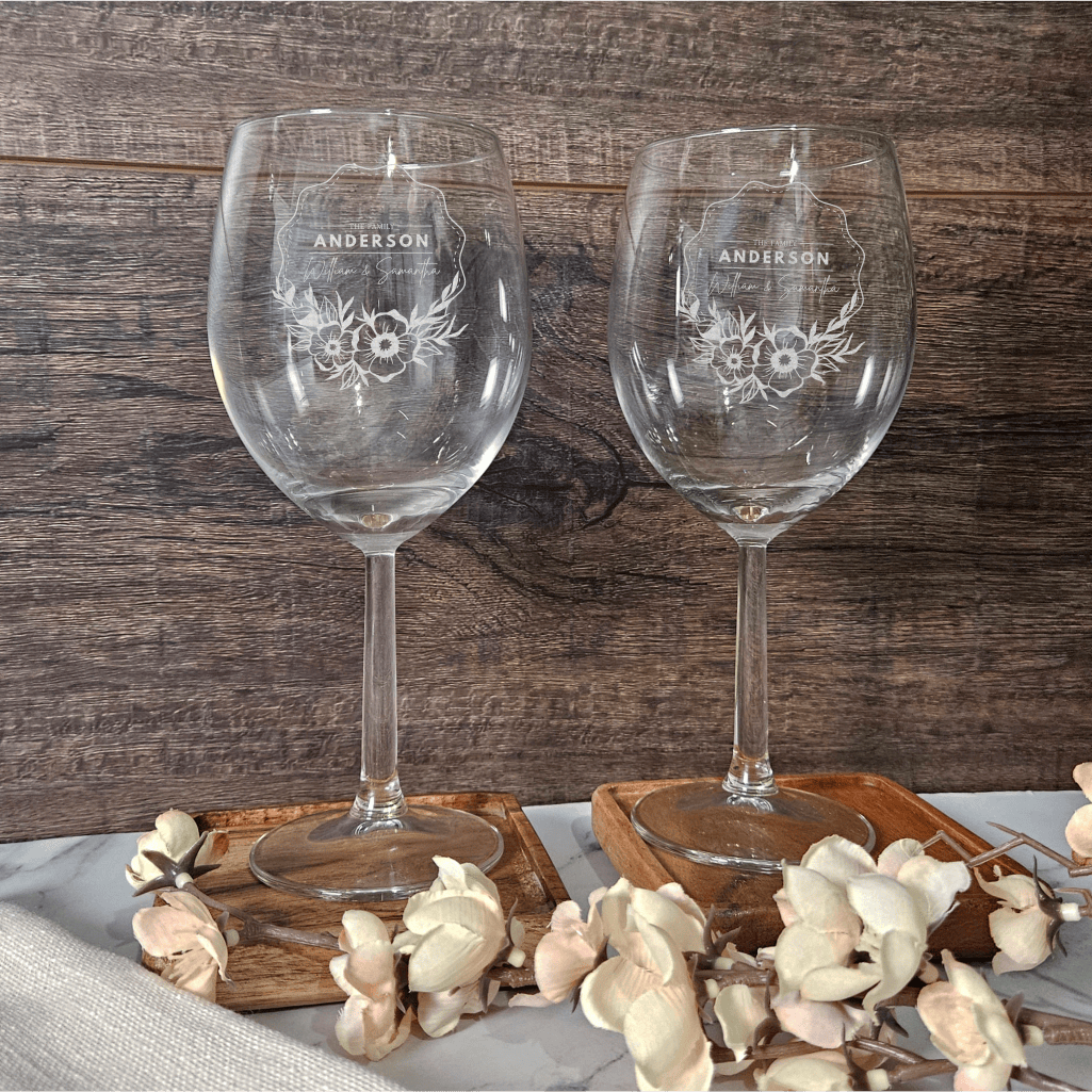 two wine glasses sitting on top of a table
