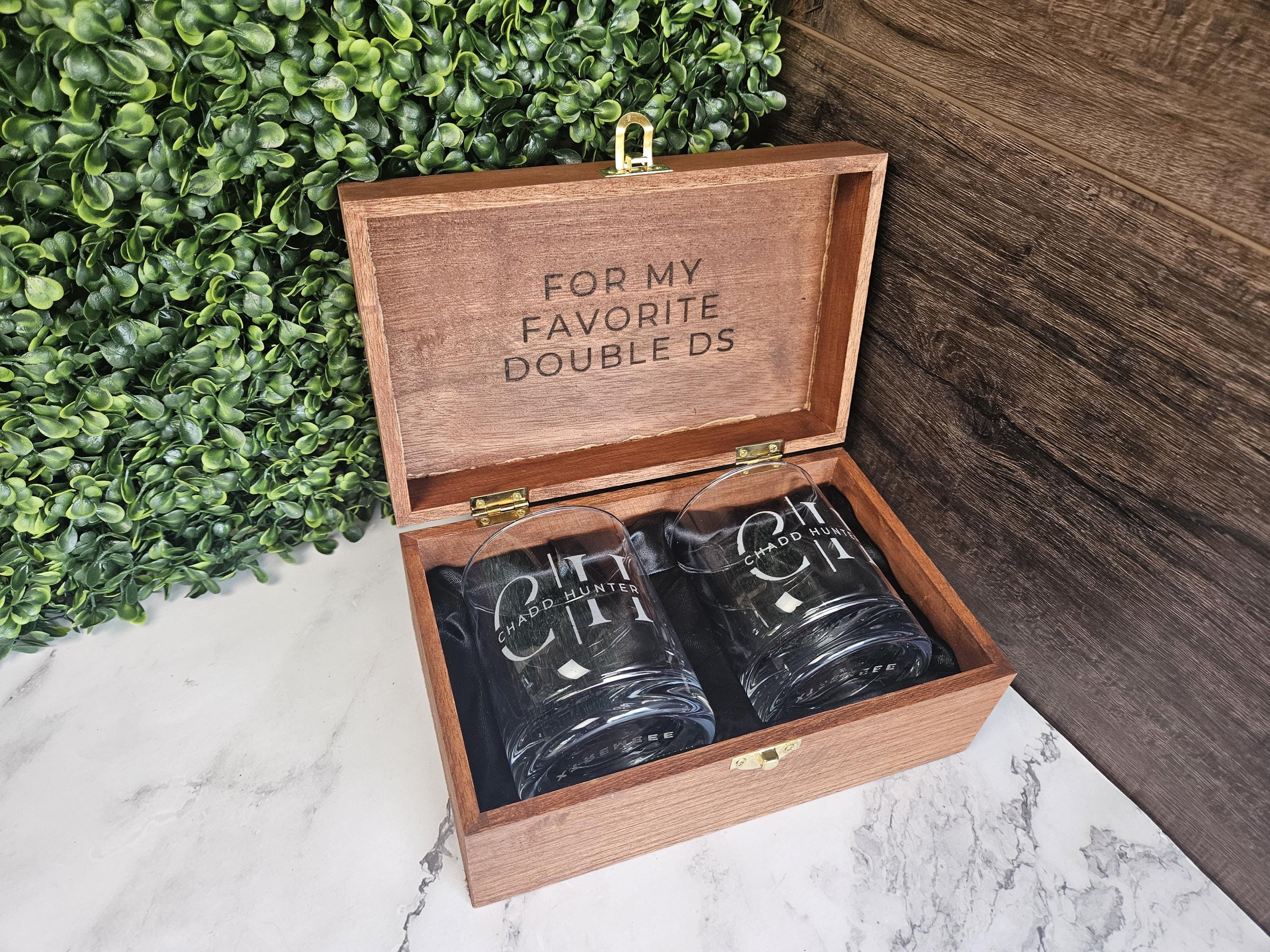 a pair of black coffee mugs in a wooden box