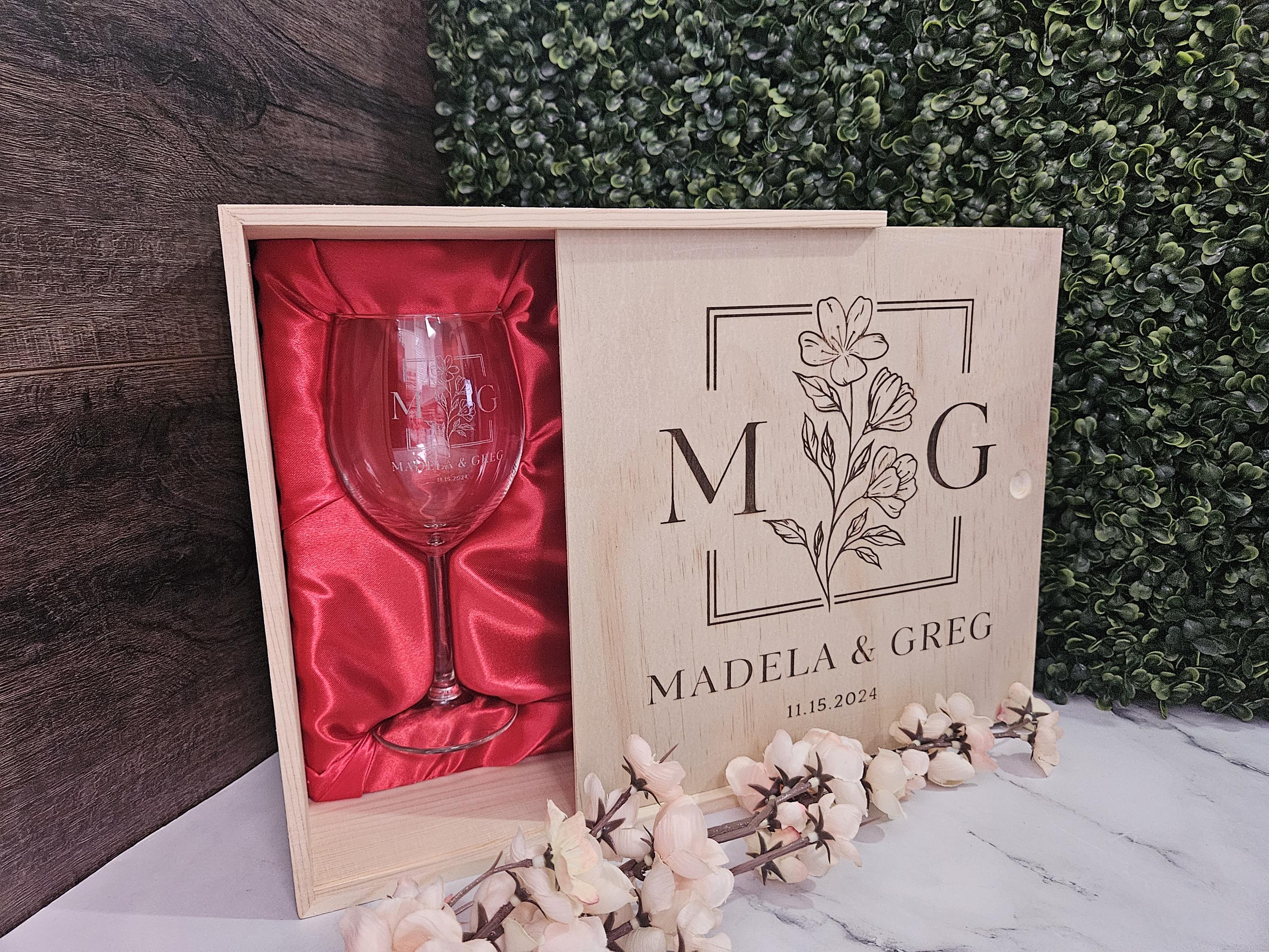 a wooden box with a wine glass inside of it