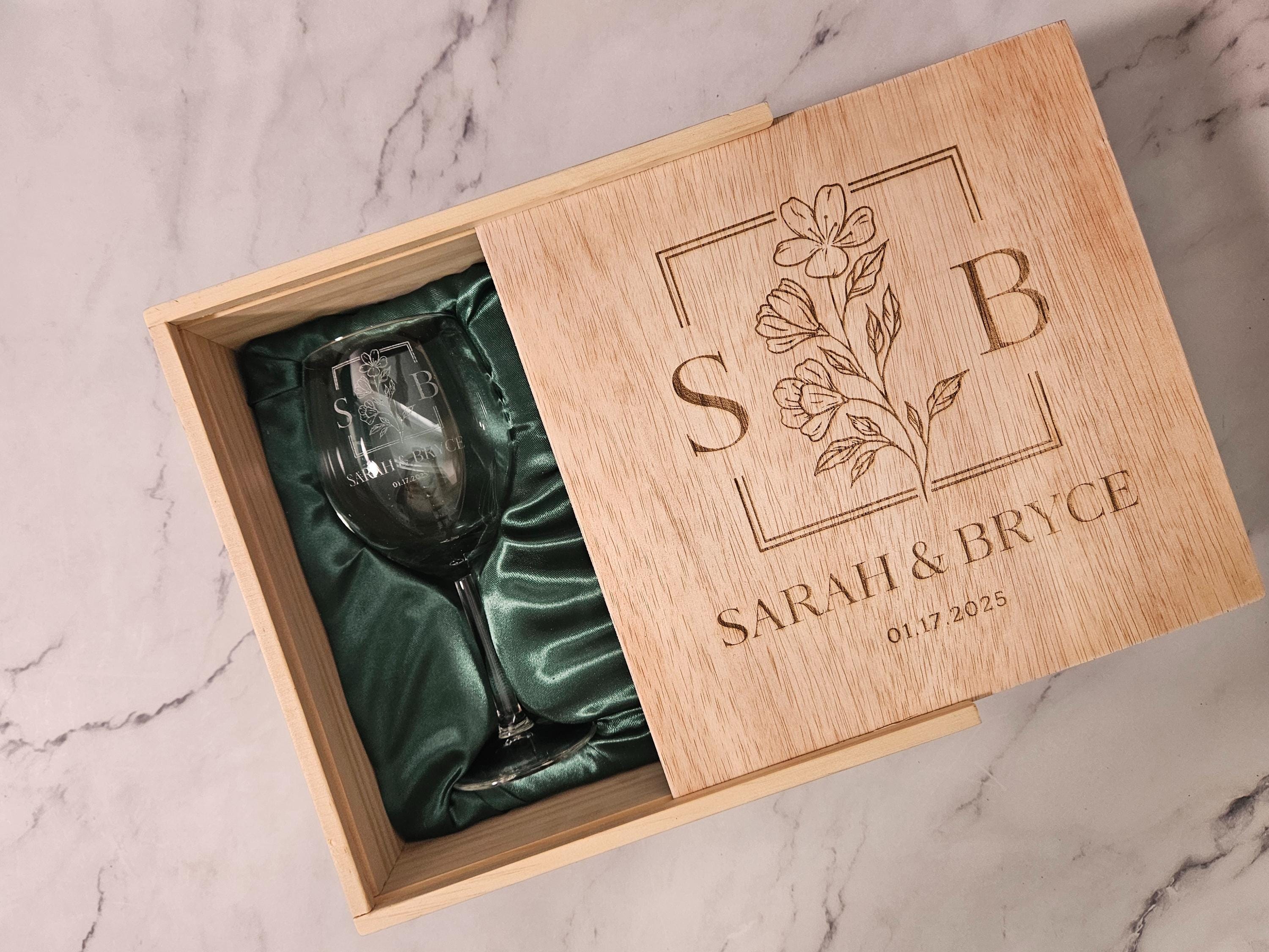 a wooden box with a wine glass inside of it