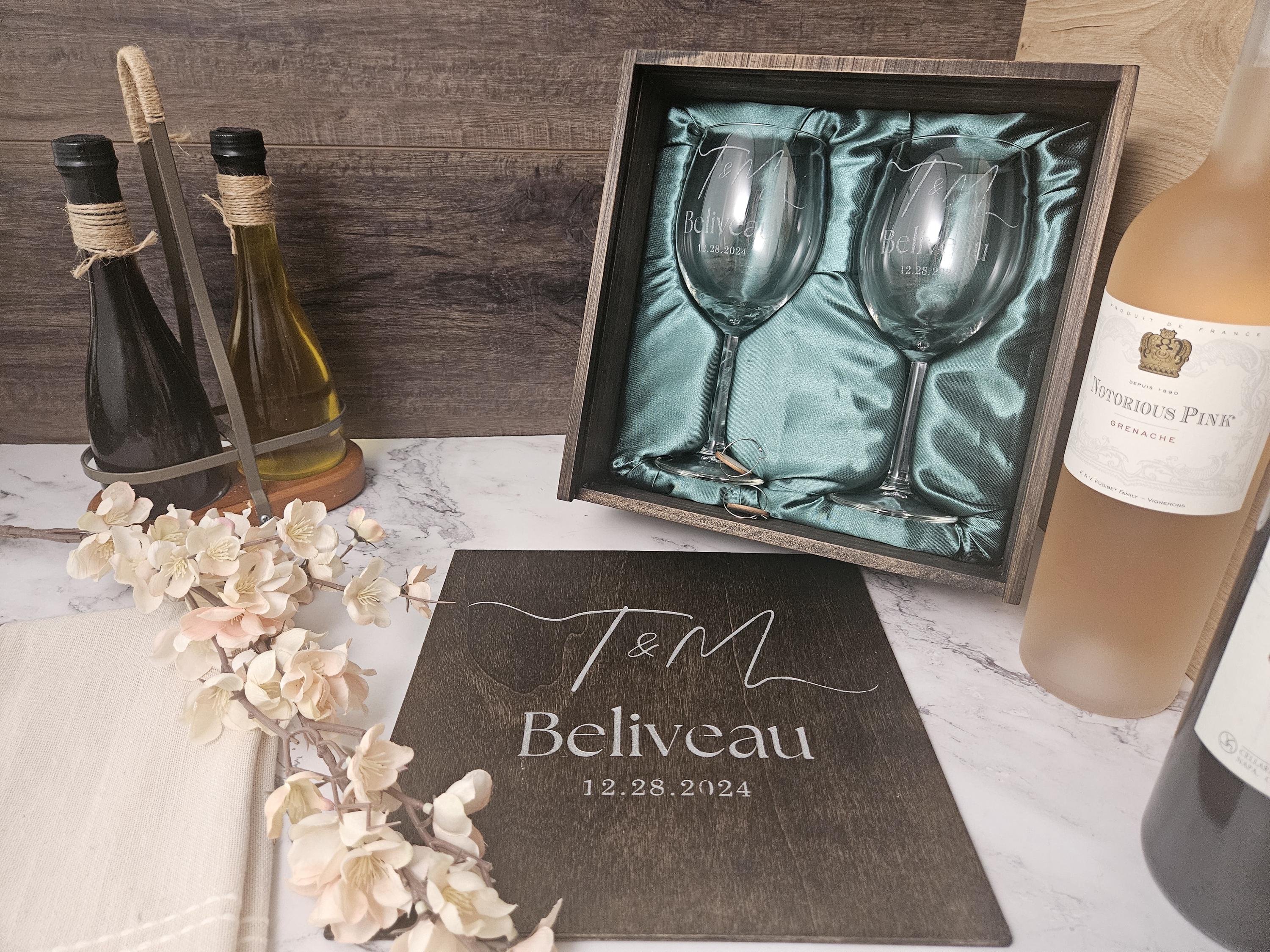 a couple of wine glasses sitting next to a bottle of wine